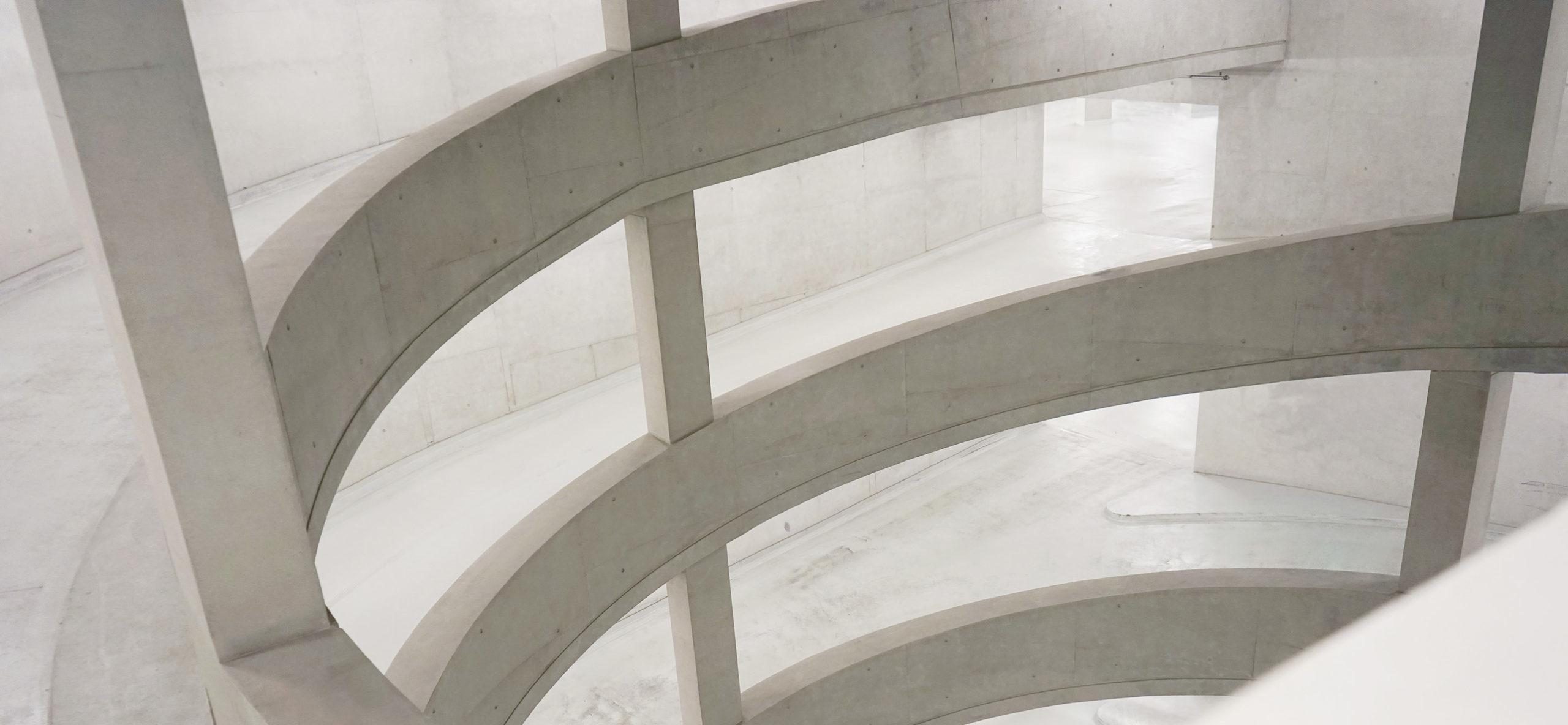 View from spiral staircase with concrete railings in modern business building
