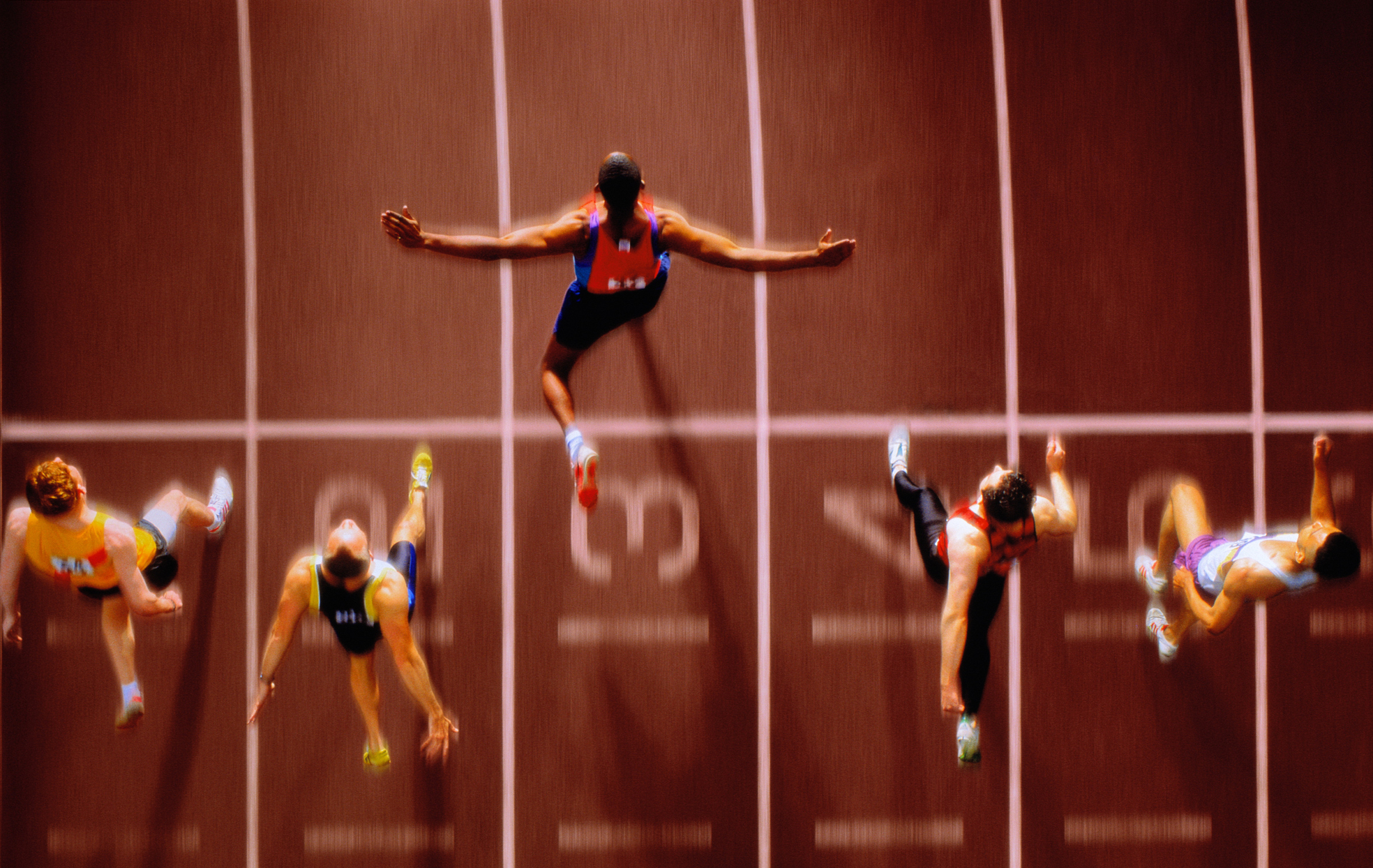 Athletes in race crossing finishing line, overhead view (Composite)